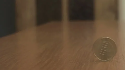 Coin on the table rotates slowly Stock Footage 39583266