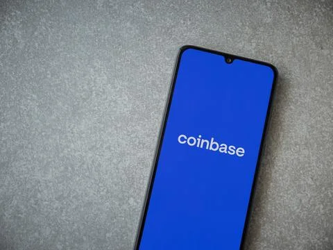 Coinbase app launch screen on smartphone on ceramic stone background Stock Photos