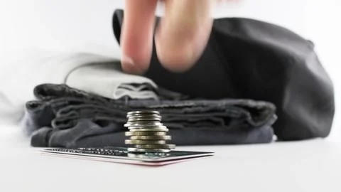 Coins and clothes on a white background. Vídeo Stock 206250949