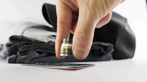 Coins and clothes on a white background. Vídeo Stock 206251027