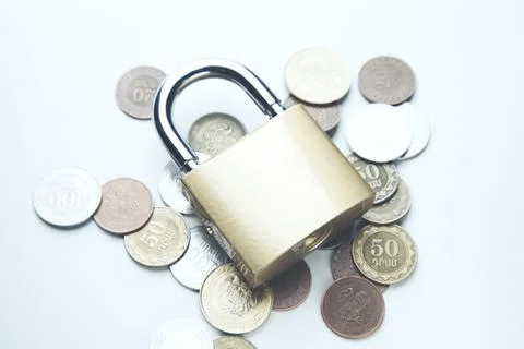 Coins and lock on  table Stock Photos