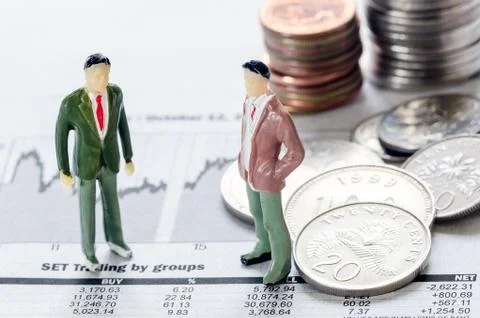 Coins and mini model Stock Photos