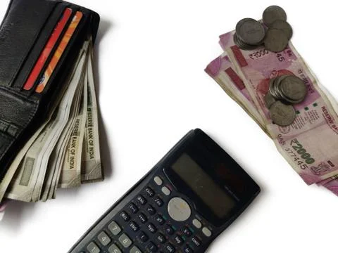 Coins and notes counting or calculation by calculator on white background Stock Photos