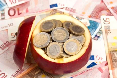 Coins on apple Stock Photos