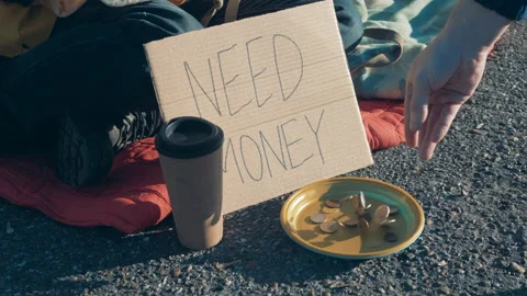 Coins are getting thrown into beggar's plate Vidéo 168128978