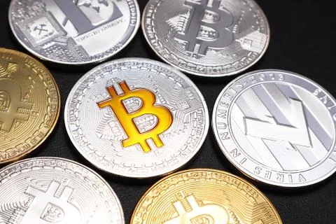 Coins of Bitcoin and Litecoin on black textured background. Stock Illustration