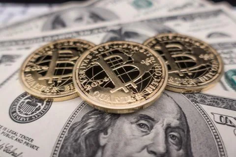 Coins of bitcoin on dollar notes Stock Photos