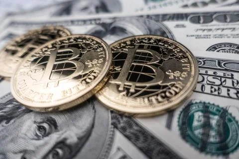 Coins of bitcoin on dollar notes Stock Photos
