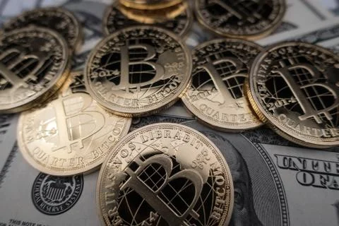 Coins of bitcoin on dollar notes Stock Photos