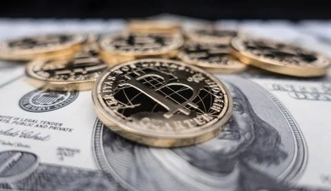 Coins of bitcoin on dollar notes Stock Photos
