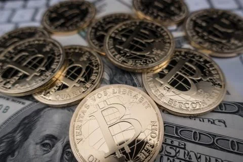Coins of bitcoin on dollar notes Stock Photos