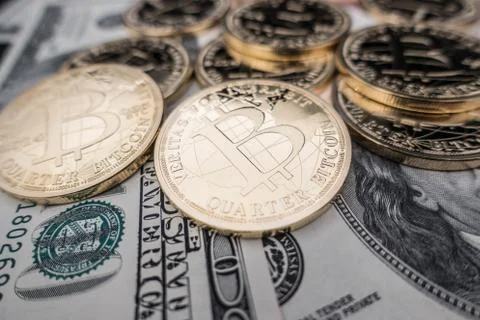 Coins of bitcoin on dollar notes Stock Photos