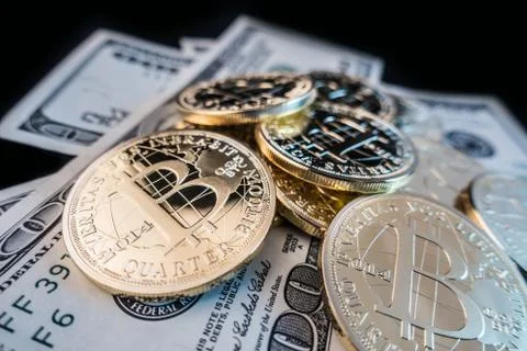 Coins of bitcoin on dollar notes Stock Photos