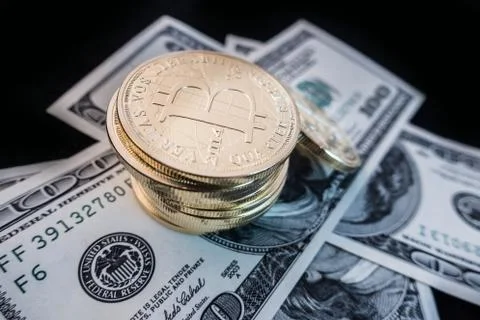 Coins of bitcoin on dollar notes Stock Photos