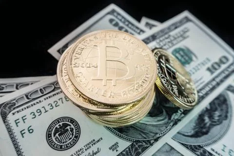 Coins of bitcoin on dollar notes Stock Photos