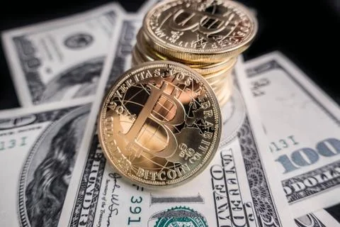 Coins of bitcoin on dollar notes Stock Photos