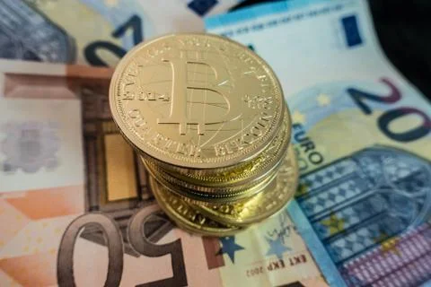 Coins of bitcoin on dollar notes Stock Photos