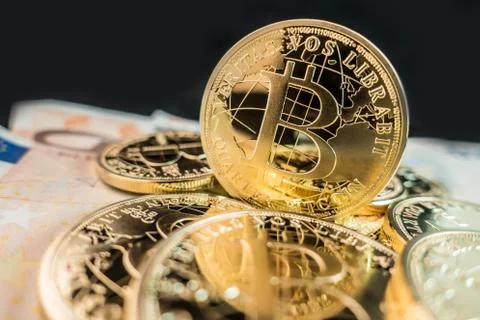 Coins of bitcoin on dollar notes Stock Photos