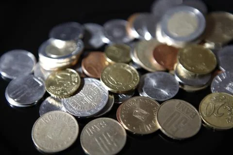 Coins on black Stock Photos