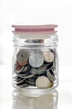 Coins in the bottle Stock Photos