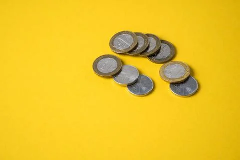 Coins close-up on a yellow background Stock Photos