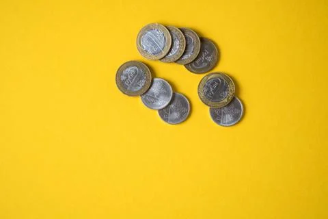 Coins close-up on a yellow background Stock Photos