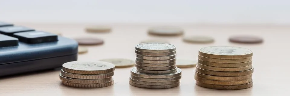 Coins in the columns on the table Stock Photos