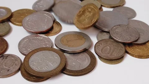 Coins of different countries are slowly falling on a white background Video stock 127514538