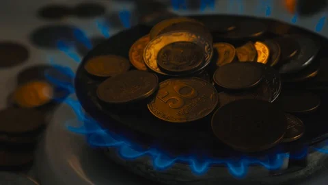 Coins of different countries on a gas burner. Symbol of increasing fuel prices. Stock Footage 107787789