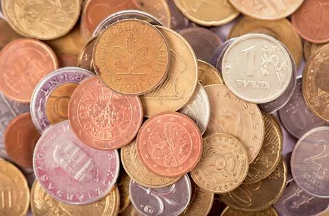 Coins of different countries on a white background. Stock Photos