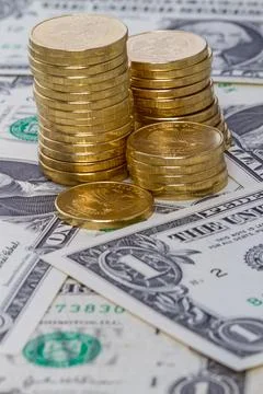 Coins on dollar Stock Photos