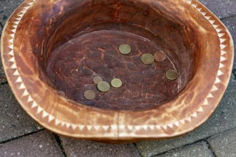 Coins earned in a hat. Stock Photos