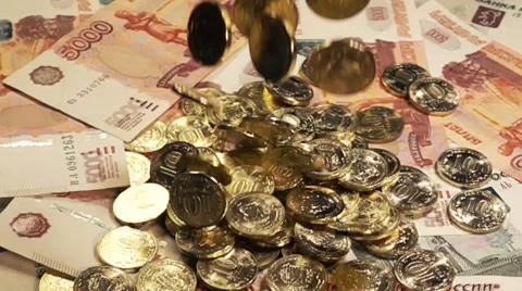 Coins fall on the notes and turn in slow motion Stock-Footage 64570393