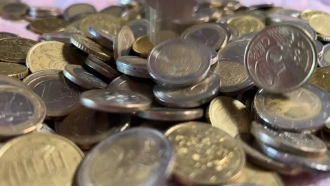 Coins fall into pile in slow motion Stock Footage 223862778