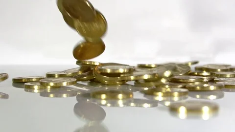 Coins fall on a white, slow-motion shot Stock Footage 77540808