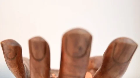 Coins falling into a giant hand Stock Footage 127124033