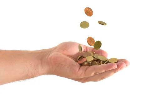 Coins falling in a hand in a white background Stock Photos