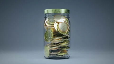 Coins falling inside glass jar until fill it over. Money saving Видео 169974607