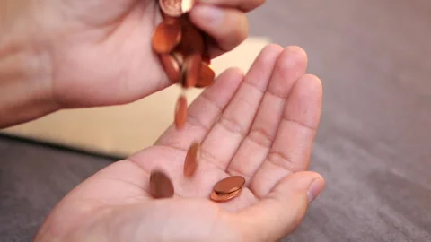 Coins falling in person's hands. Making money and great savings Stock-Footage 136210075