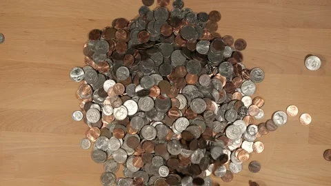 Coins falling into a pile of change Stock Footage 167573412