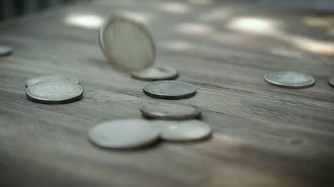 Coins Falling in Slow Motion and Hitting a Wooden Table and Each Other. Slowmo Stock Footage 136811930