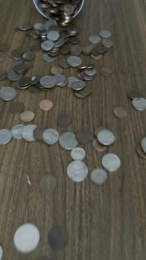 Coins Falling onto Table Close-Up - Money Finance Concept Stock Footage 303022497