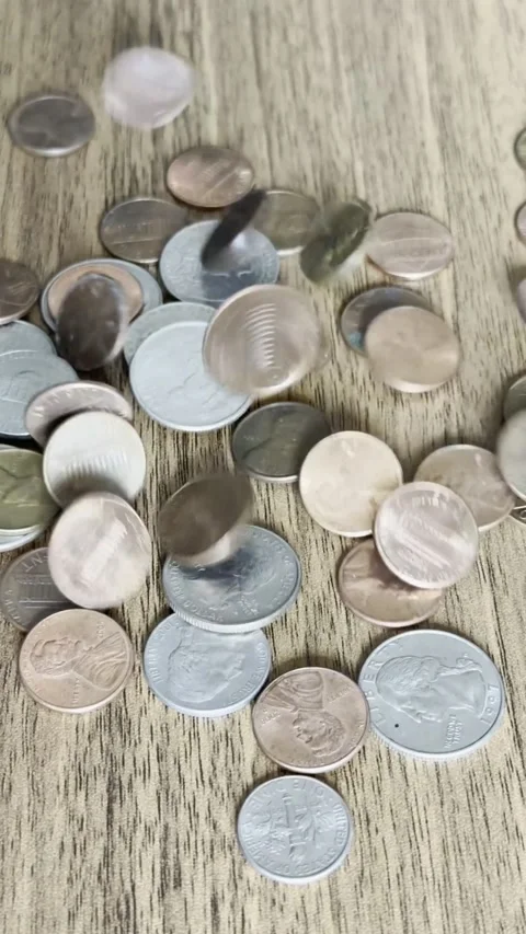 Coins Falling Onto Wooden Table Close-Up Video Stock Footage 303022511