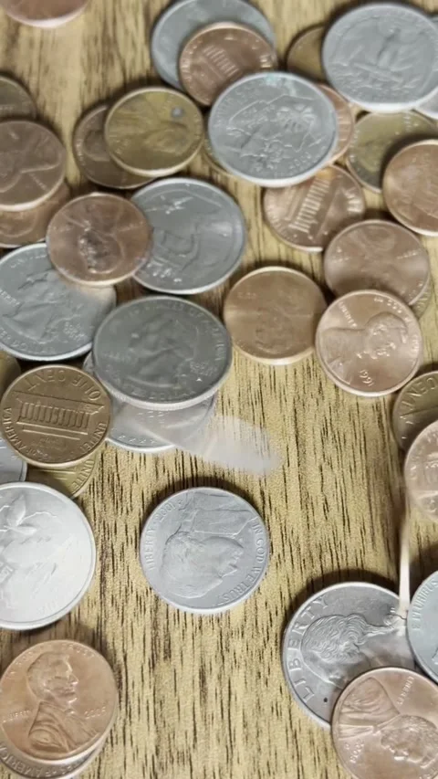 Coins Falling Onto Wooden Table Close-Up Video Stock Footage 303022513