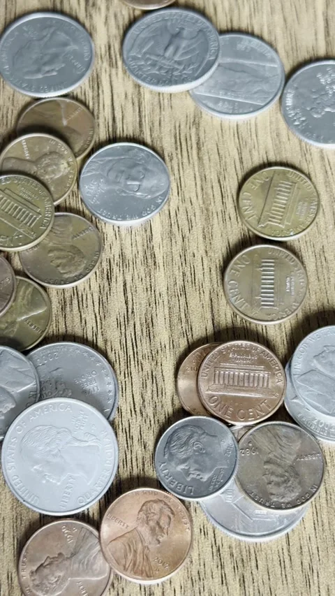 Coins Falling Onto Wooden Table Close-Up Video Stock Footage 303022526