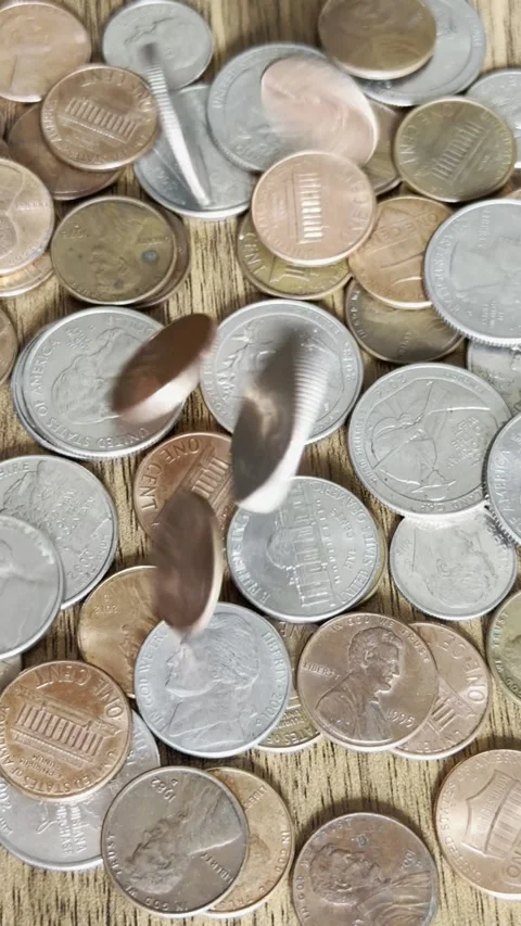 Coins Falling Onto Wooden Table Close-Up Video Stock Footage 303022554