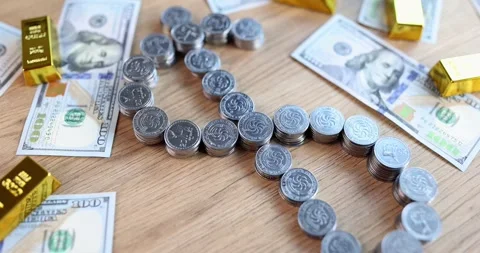 Coins form dollar symbol on table with cash and gold bars around Stock Footage 317166431