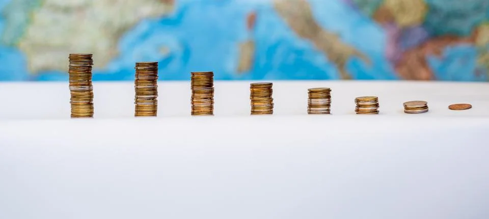 Coins in the form of a falling chart on a background of a map of Europe Stock-Fotos