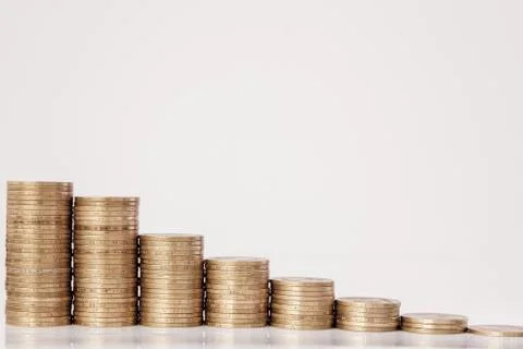 Coins in the form of a histogram on a white background. Concept of lending, s Stock Photos