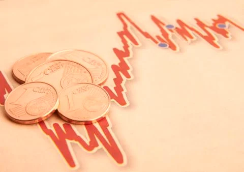 Coins on graph paper Stock Photos